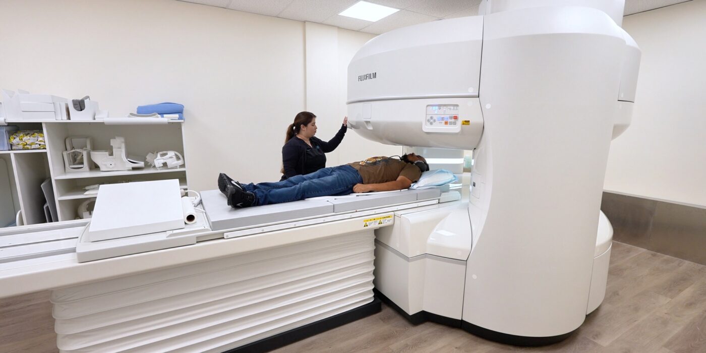 Technologist positioning a patient on the open MRI scanner at San Bernardino Open MRI in San Bernardino, CA