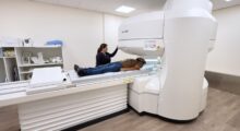 Technologist positioning a patient on the open MRI scanner at San Bernardino Open MRI in San Bernardino, CA