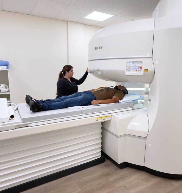 Technologist positioning a patient on the open MRI scanner at San Bernardino Open MRI in San Bernardino, CA