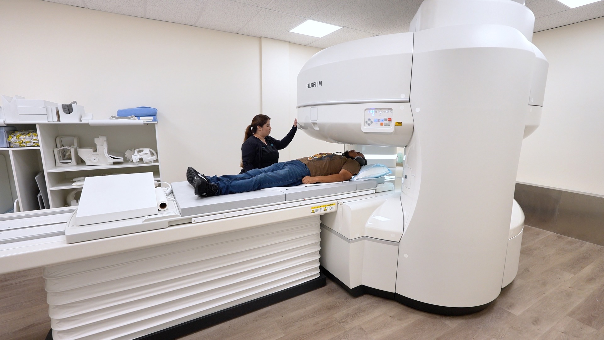 Technologist positioning a patient on the open MRI scanner at San Bernardino Open MRI in San Bernardino, CA